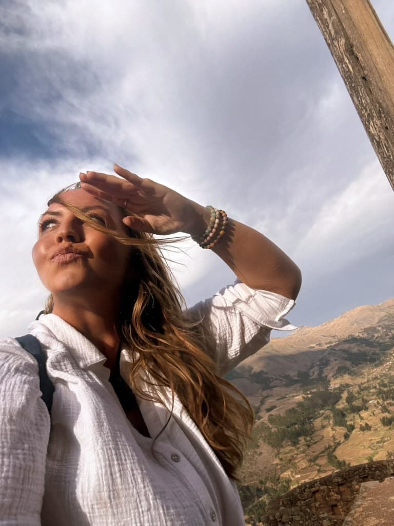 Sarah shielding her eyes against the late sun over the Sacred Valley